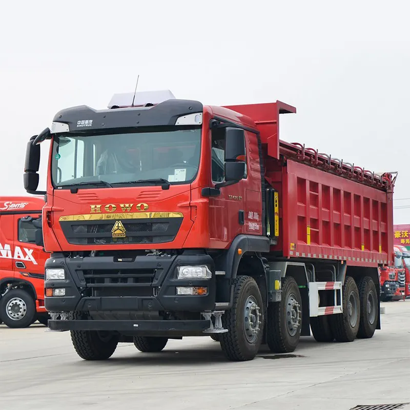 HOWO TX dump truck working in an open-pit mine, loaded with copper ore, muddy tires